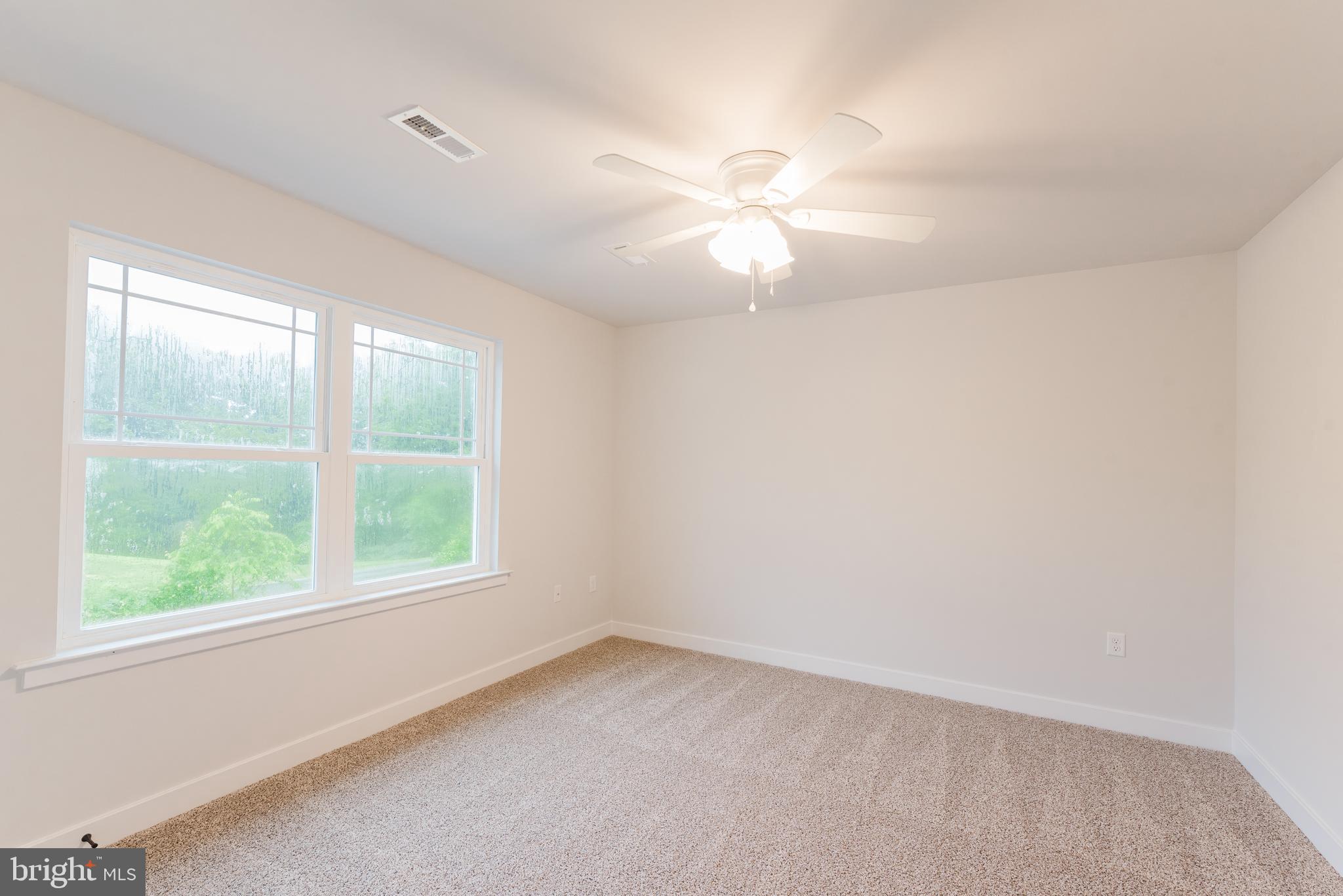 10631 Plank Road Spotsylvania, VA 22553 - Photo 6 of 26 an empty room with a window and a fan