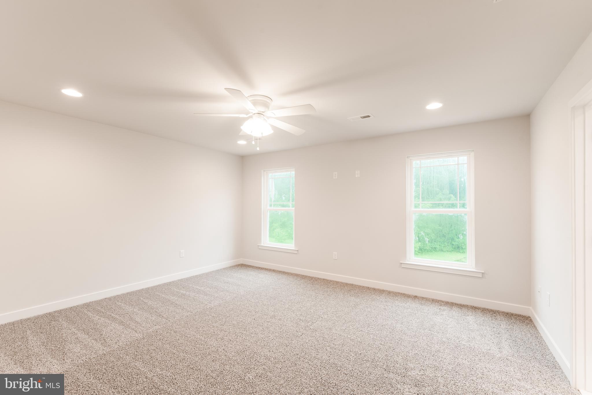 10631 Plank Road Spotsylvania, VA 22553 - Photo 8 of 26 an empty room with windows and fan