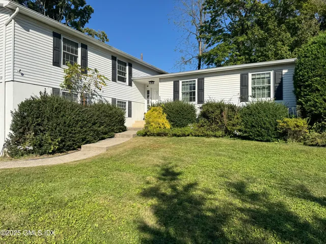 a front view of house with yard and green space