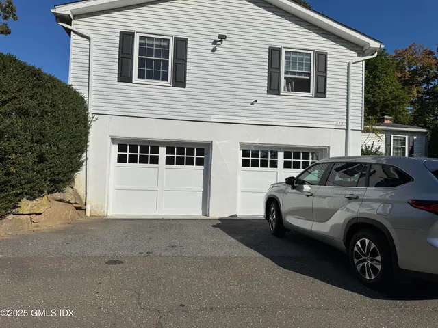 a view of a white house with large windows