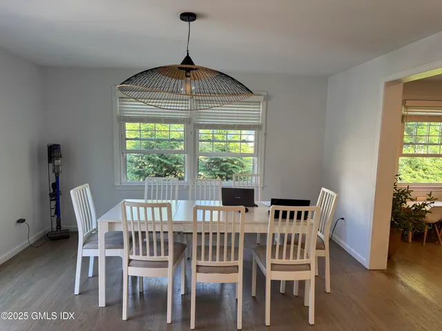 a view of a dining room with furniture window and wooden floor