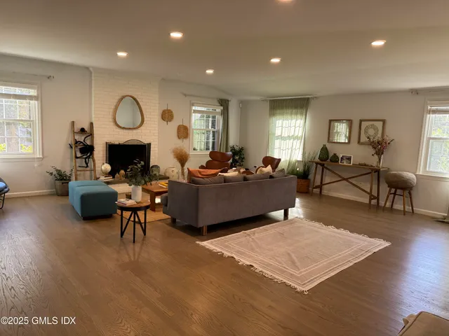 a living room with furniture a window and a clock