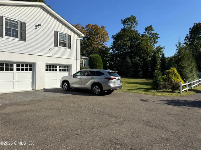 a view of a car parked in front of a house
