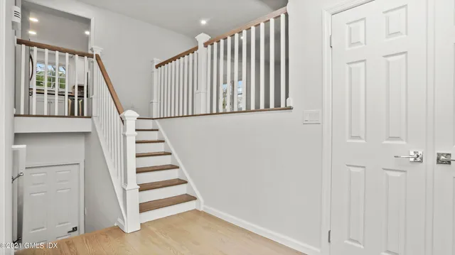 a view of staircase with white walls and windows