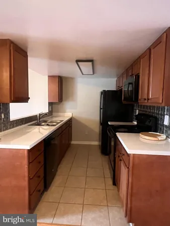 a kitchen with a sink and a refrigerator