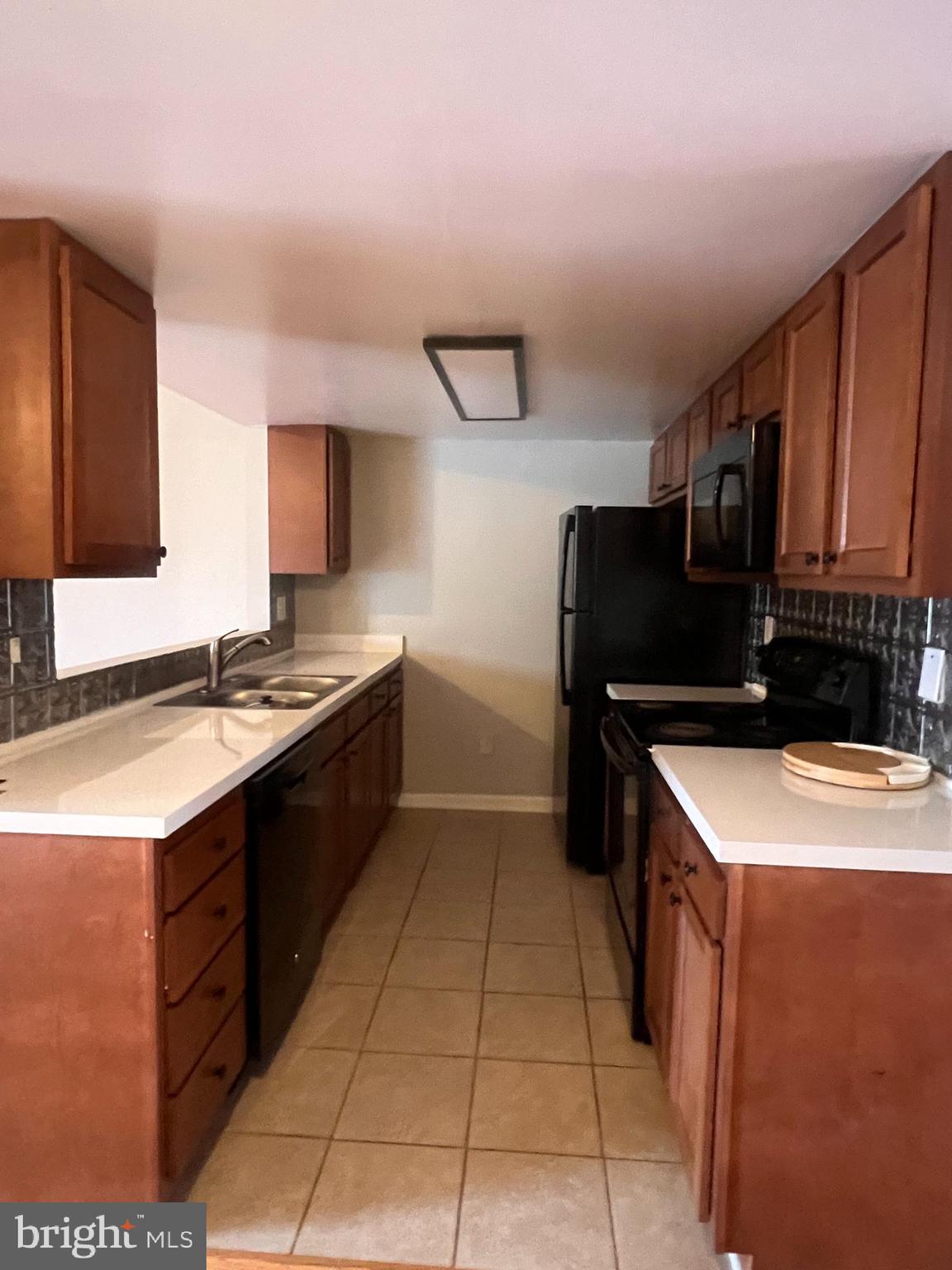 388 Dorothy Court Inwood, WV 25428 - Photo 11 of 19 a kitchen with a sink and a refrigerator