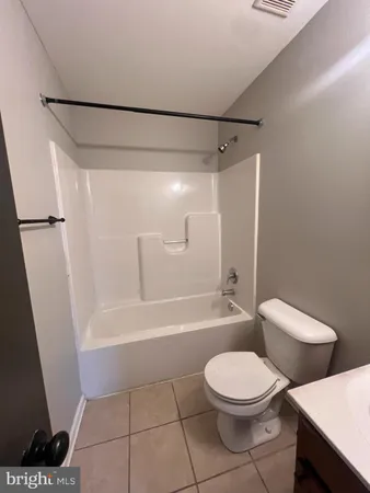 a bathroom with a toilet a sink and bathtub