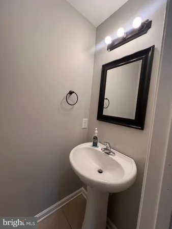 a bathroom with a sink a mirror and vanity
