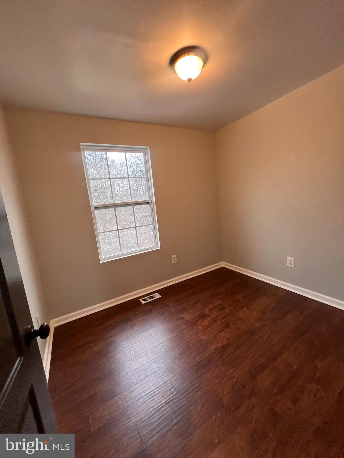 388 Dorothy Court Inwood, WV 25428 - Photo 4 of 19 an empty room with wooden floor and windows
