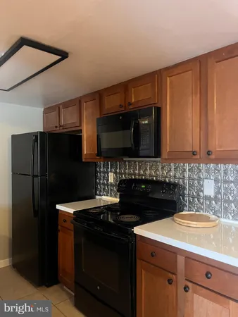 a kitchen with a refrigerator stove and cabinets