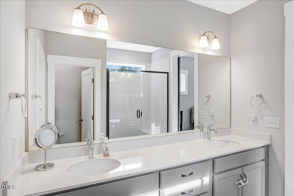 1105 Logperch Way Wendell, NC 27591 - Photo 14 of 29 a bathroom with a sink double vanity and a mirror