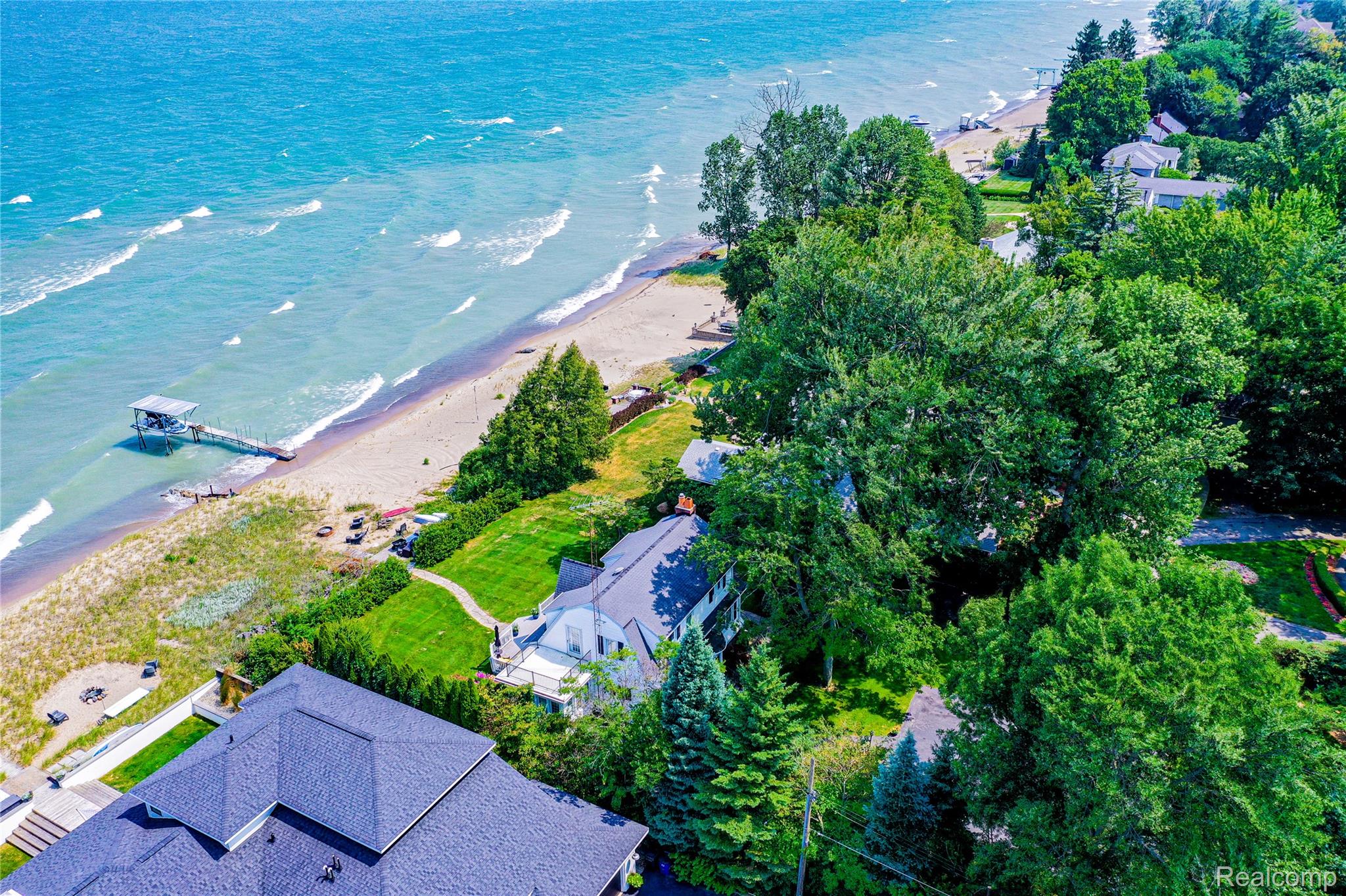 5630 Lakeshore Road Fort Gratiot, MI 48059 - Photo 37 of 49 Coastal property featuring a significant waterfront presence, private sandy beach access, a pier, and mature trees