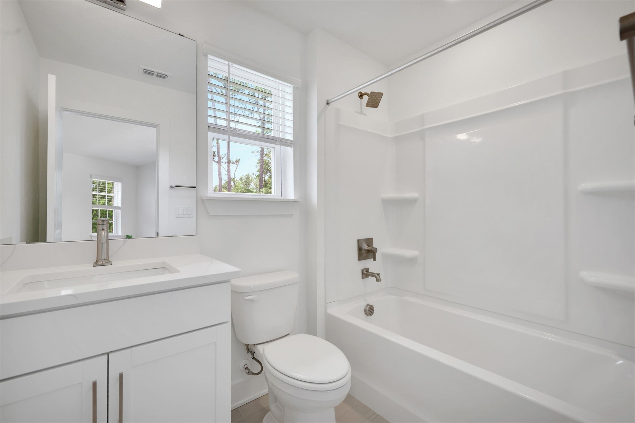96040 Pirates Bluff Road Yulee, FL 32097 - Photo 30 of 38 a bathroom with a bathtub toilet sink vanity and windows