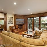 a living room with furniture and large windows