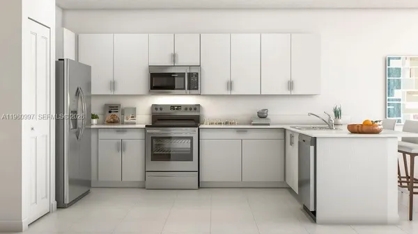 a kitchen with stainless steel appliances white cabinets and a refrigerator