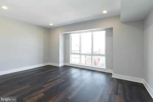 a view of wooden floor and windows in a room