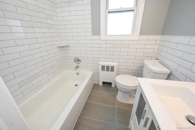 a bathroom with a bathtub and toilet