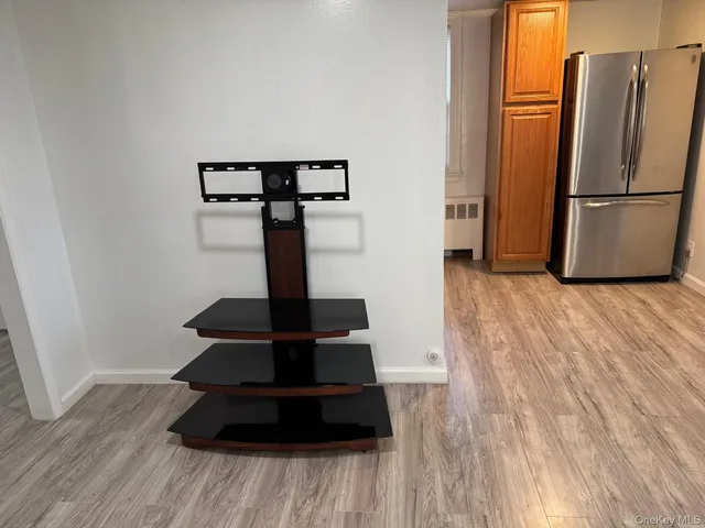 a view of a refrigerator in kitchen and wooden floor