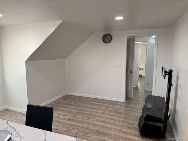 a view of a livingroom with wooden floor and furniture