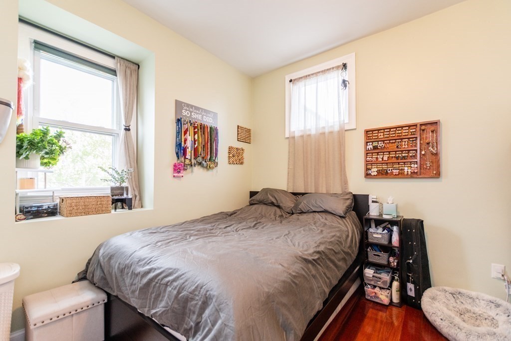 10 Beacon Street, Unit 3 Chelsea, MA 02150 - Photo 11 of 29 a bedroom with a bed and a table with window