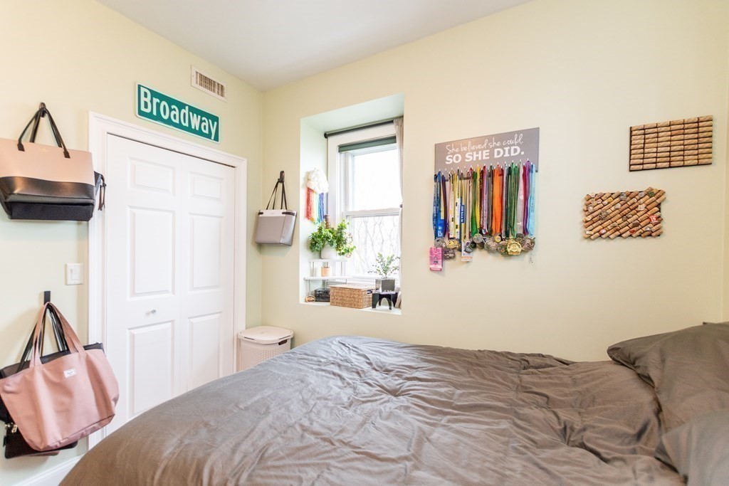 10 Beacon Street, Unit 3 Chelsea, MA 02150 - Photo 12 of 29 a bedroom with a bed and a cabinets