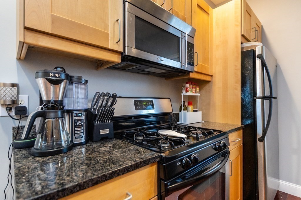10 Beacon Street, Unit 3 Chelsea, MA 02150 - Photo 15 of 29 a kitchen with a stove and a microwave
