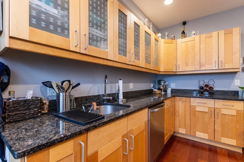 10 Beacon Street, Unit 3 Chelsea, MA 02150 - Photo 2 of 29 a kitchen with stainless steel appliances granite countertop a sink stove and cabinets