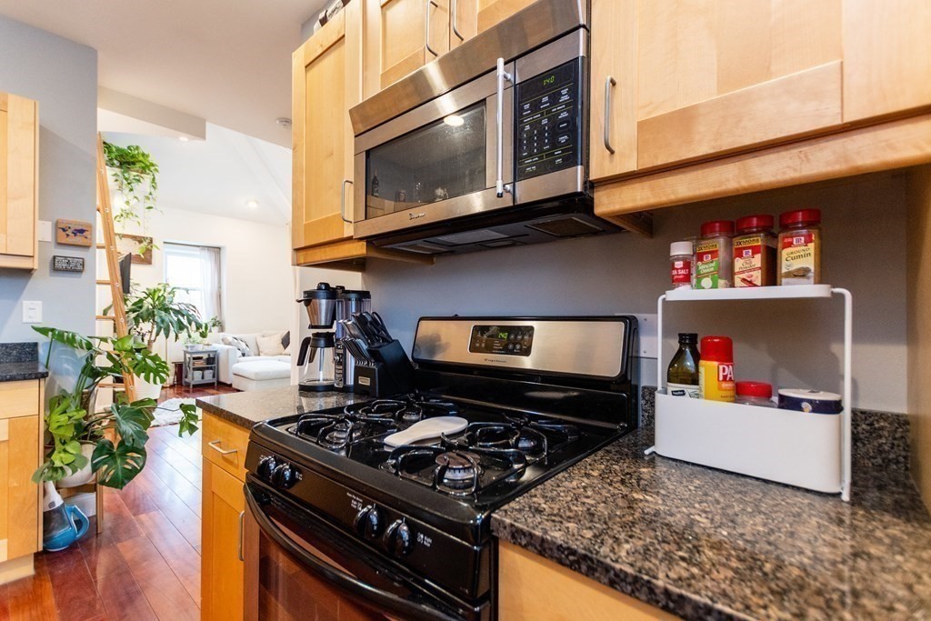 10 Beacon Street, Unit 3 Chelsea, MA 02150 - Photo 4 of 29 a kitchen with a stove and a microwave