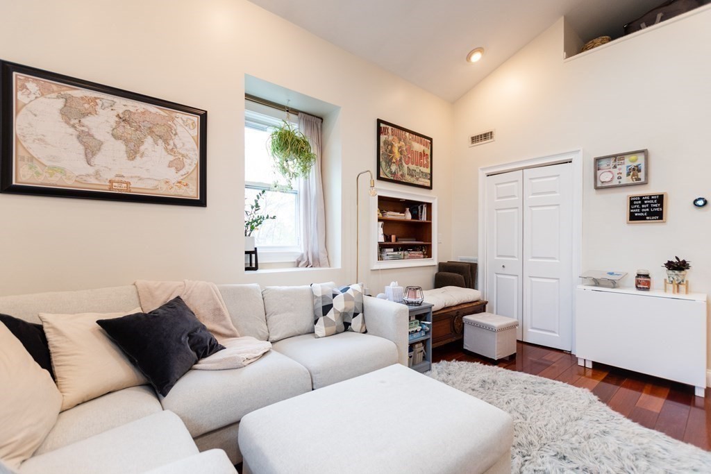10 Beacon Street, Unit 3 Chelsea, MA 02150 - Photo 9 of 29 a living room with furniture and paintings on the wall