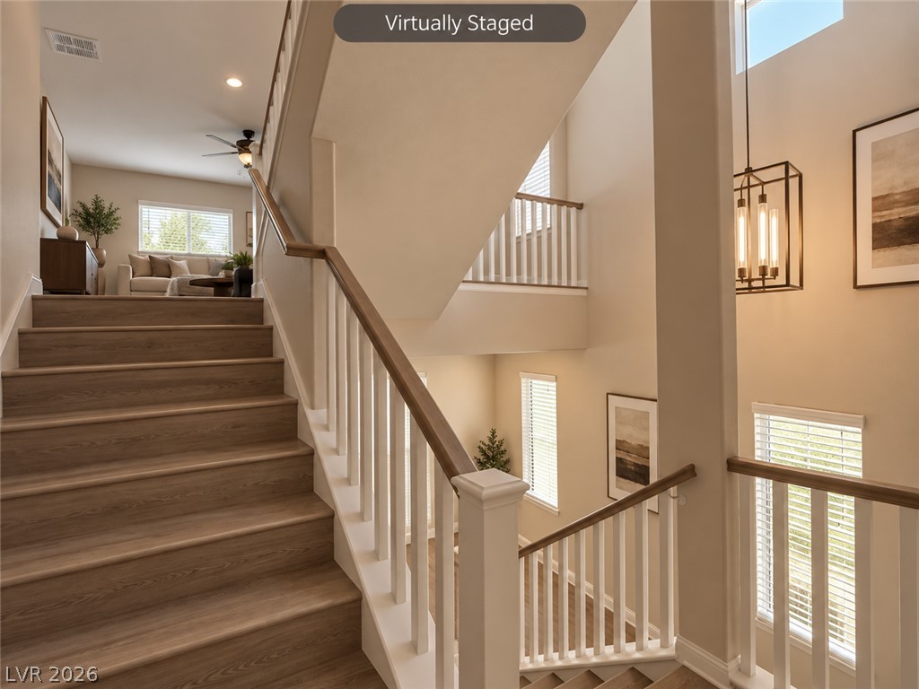 8059 Encanterra Road Las Vegas, NV 89113 - Photo 16 of 52 Multi-level wooden staircases connect the light-filled spaces of this modern interior layout.