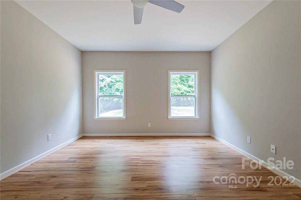 2138 Bluebell Way Tega Cay, SC 29708 - Photo 8 of 20 an empty room with wooden floor and windows