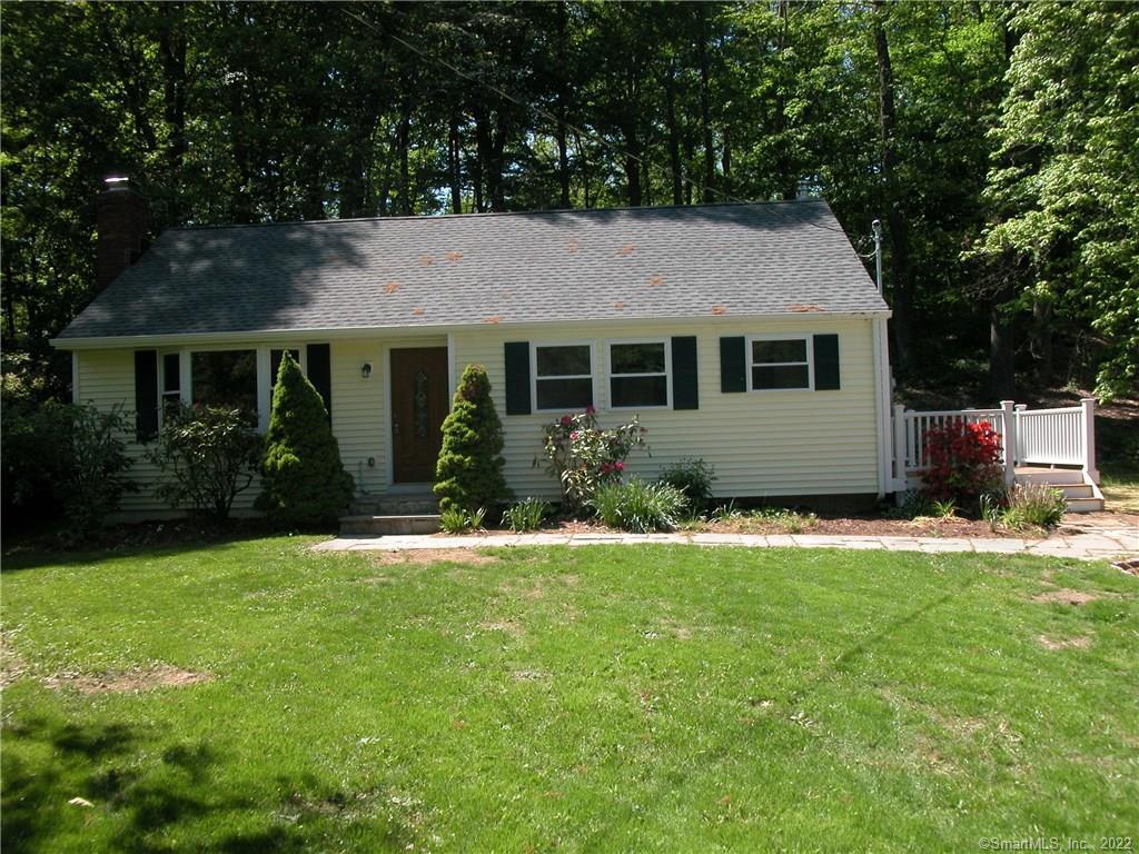 39 Midrocks Road Ridgefield, CT 06877 - Photo 1 of 1 a front view of house with yard and green space