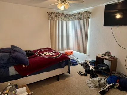 a bedroom with a bed and a flat screen tv