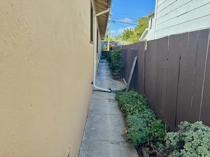a view of a pathway with a wooden fence