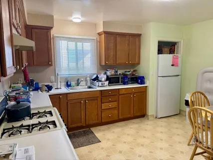 a kitchen with a sink stove and refrigerator