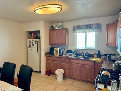 a kitchen with a refrigerator and sink
