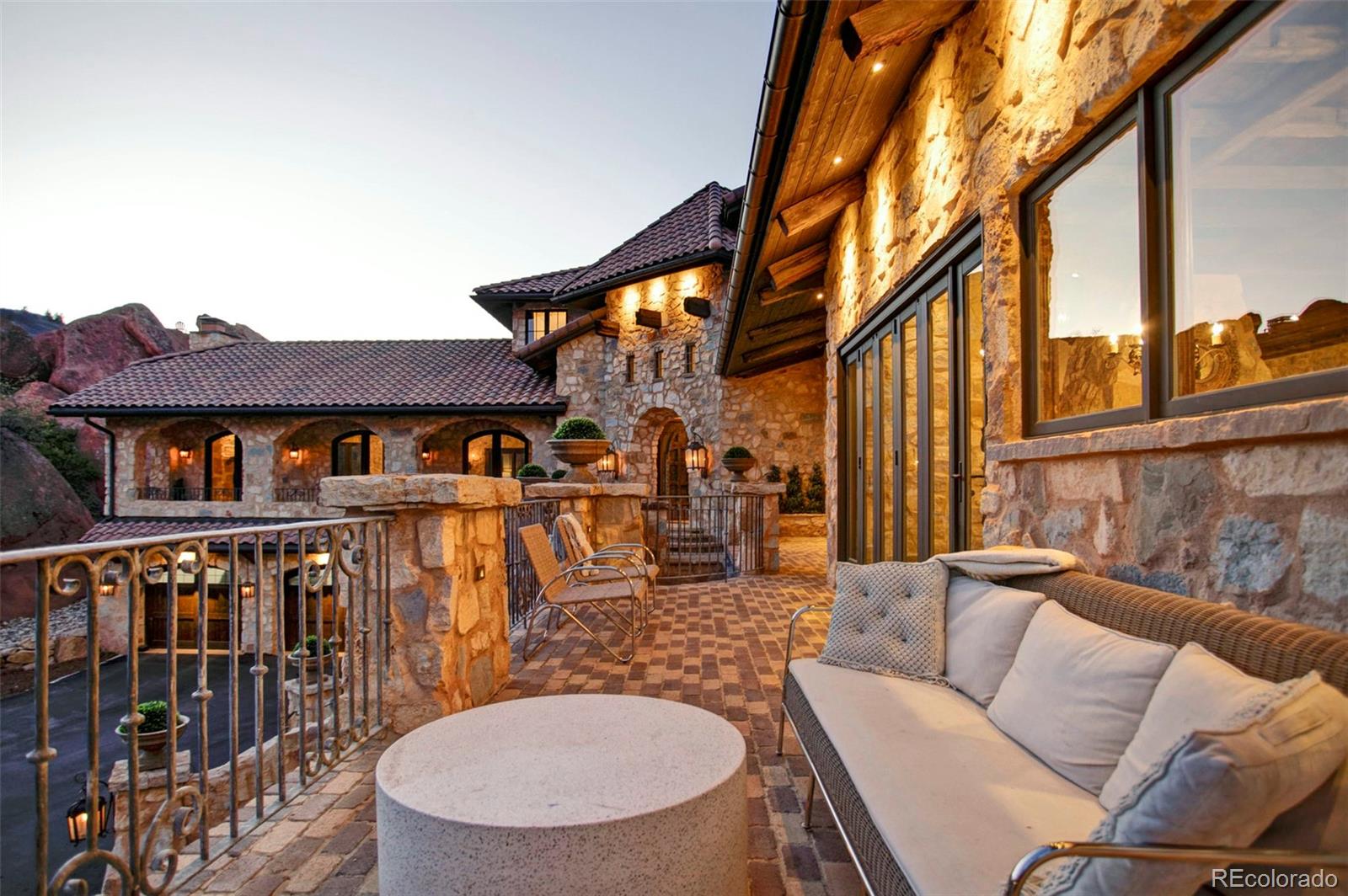 3755 North Rampart Range Road Littleton, CO 80125 - Photo 19 of 50 a view of a patio with couches table and chairs and wooden floor