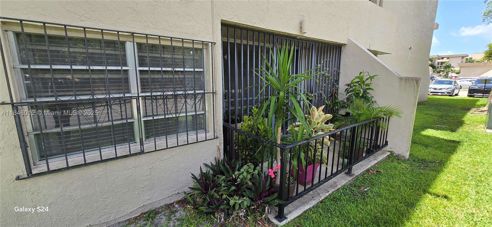 816 Northwest 87th Avenue, Unit 107 Miami, FL 33172 - Photo 13 of 20 a view of a house with a flower garden