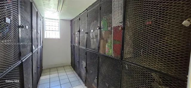 a kitchen with a refrigerator a stove top oven and cabinets