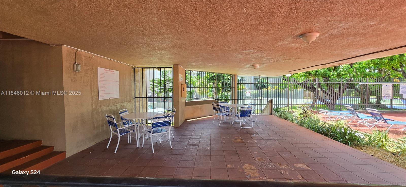816 Northwest 87th Avenue, Unit 107 Miami, FL 33172 - Photo 18 of 20 a patio with table and chairs