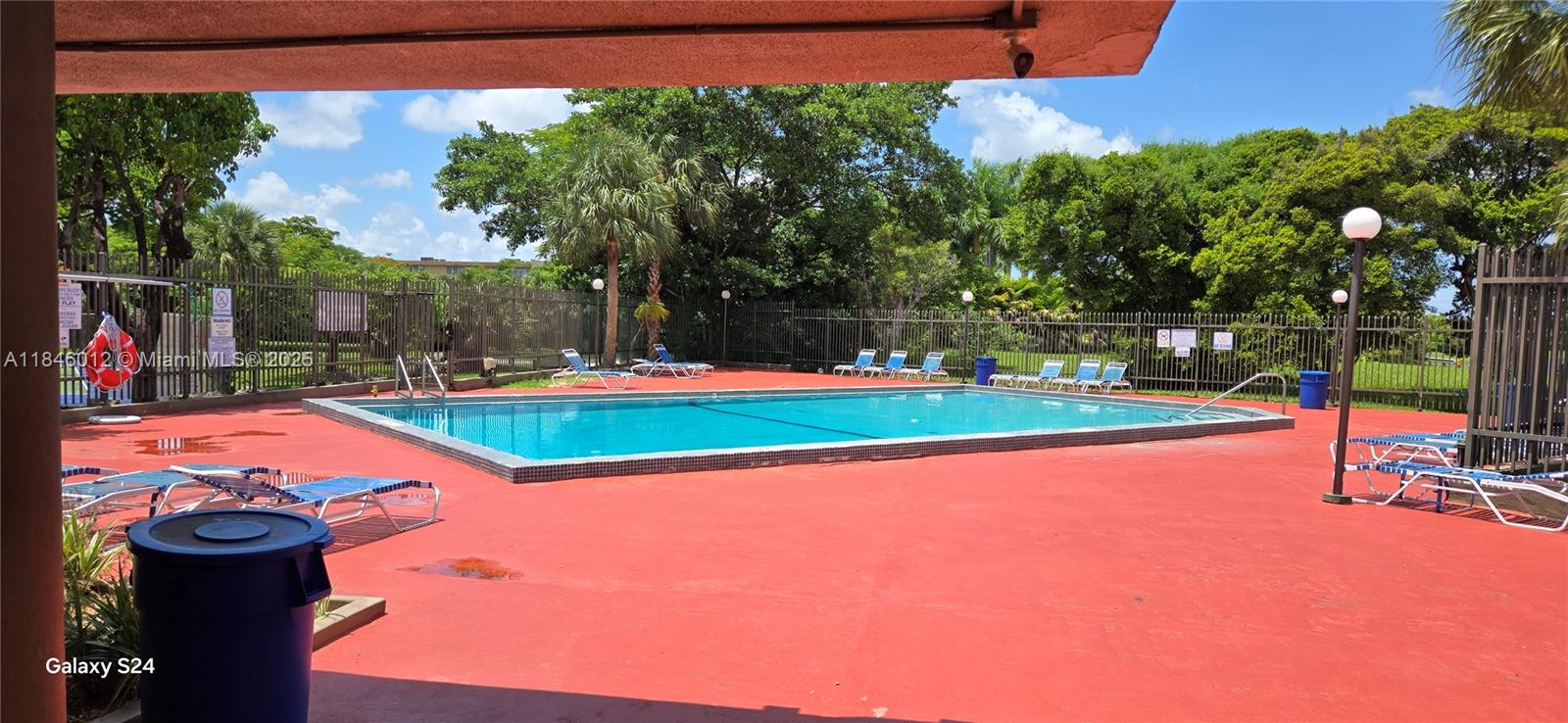 816 Northwest 87th Avenue, Unit 107 Miami, FL 33172 - Photo 19 of 20 a view of a backyard with swimming pool and deck