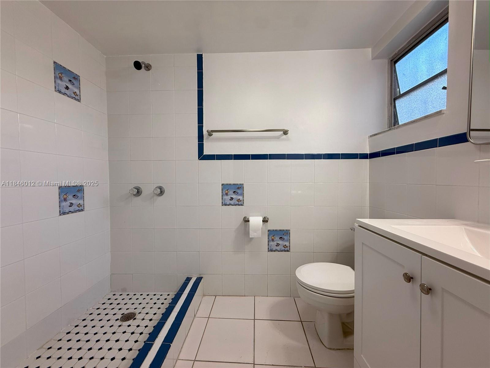 816 Northwest 87th Avenue, Unit 107 Miami, FL 33172 - Photo 9 of 20 a bathroom with a toilet and a shower