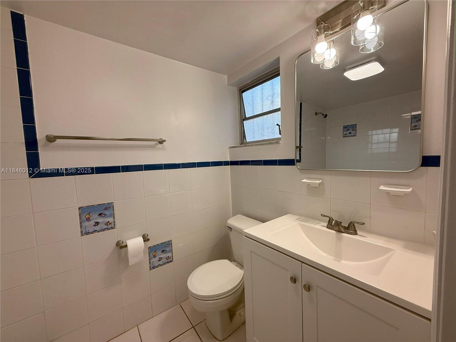 816 Northwest 87th Avenue, Unit 107 Miami, FL 33172 - Photo 10 of 20 a bathroom with a sink and a mirror
