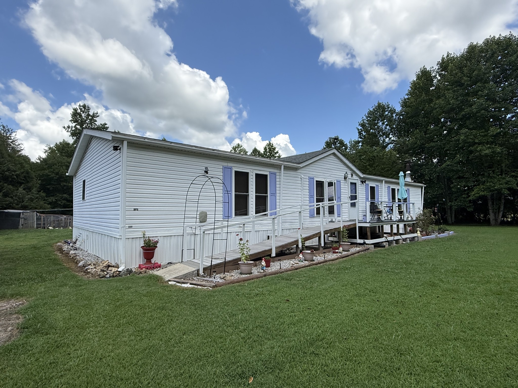 a view of a house with a yard and garden