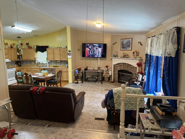 a view of a livingroom with furniture and a flat screen tv