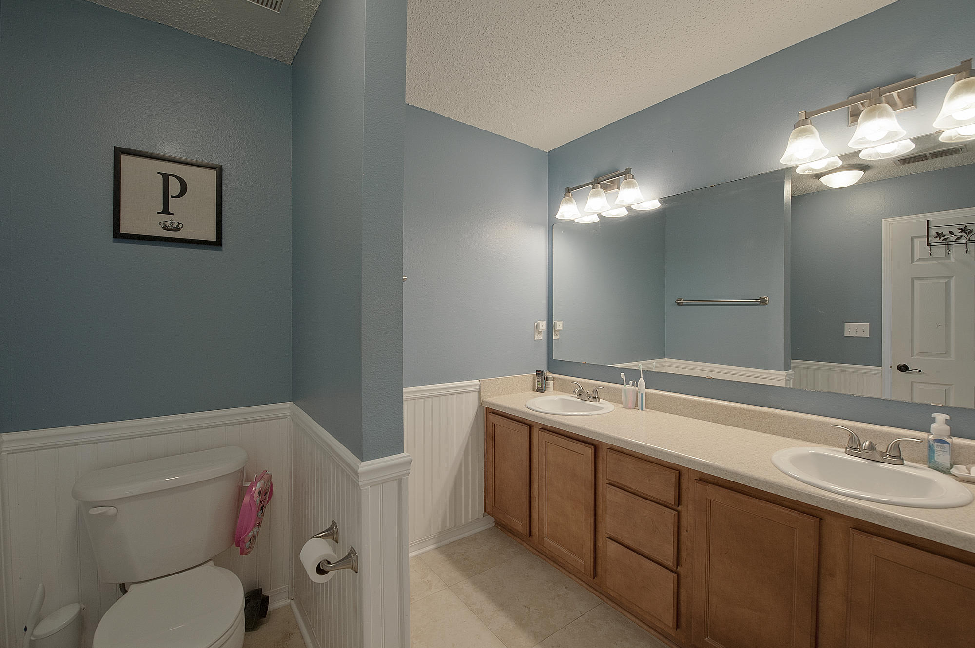 291 Limestone Circle Crestview, FL 32539 - Photo 13 of 19 a bathroom with a sink a toilet a mirror and vanity
