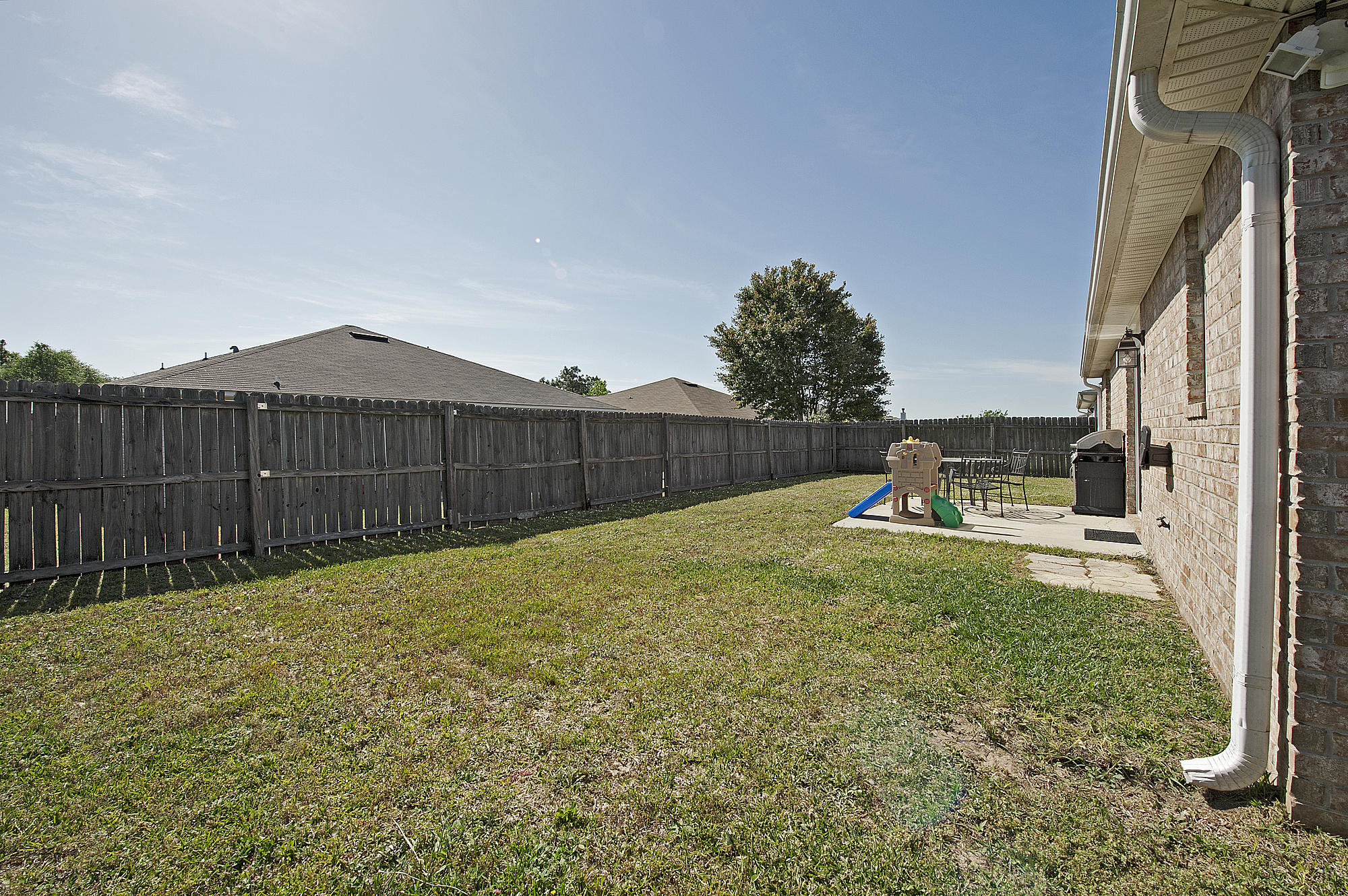 291 Limestone Circle Crestview, FL 32539 - Photo 17 of 19 a view of a backyard with wooden fence