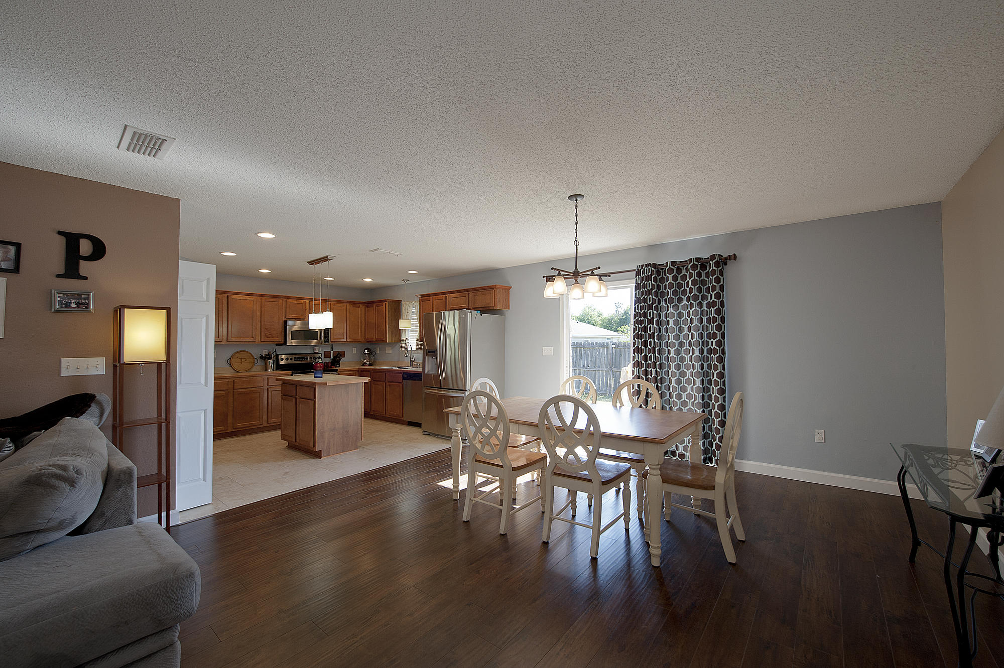 291 Limestone Circle Crestview, FL 32539 - Photo 5 of 19 a view of a dining room with furniture window and wooden floor