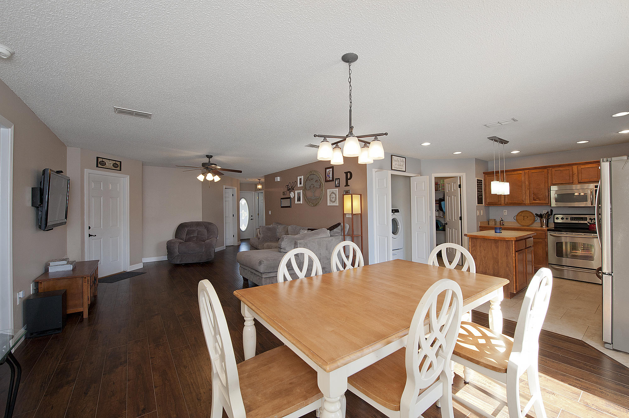 291 Limestone Circle Crestview, FL 32539 - Photo 6 of 19 a view of a dining room and livingroom with furniture wooden floor a chandelier