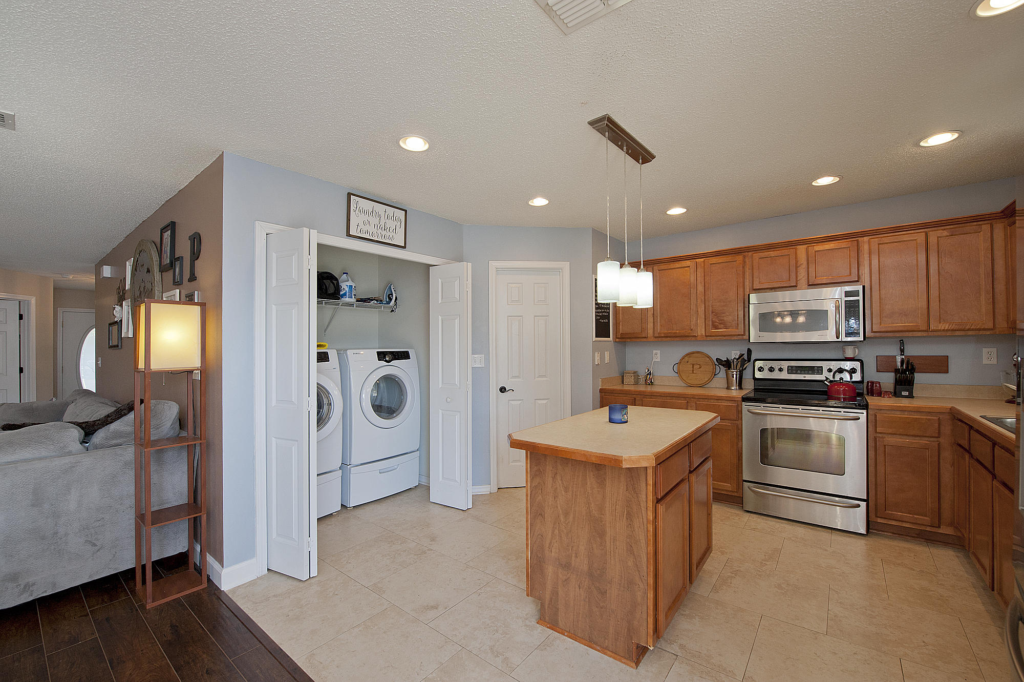 291 Limestone Circle Crestview, FL 32539 - Photo 7 of 19 a kitchen with stainless steel appliances granite countertop a refrigerator oven stove a sink dishwasher and a refrigerator with wooden floor